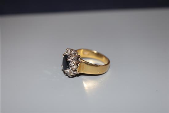 A modern 18ct gold, sapphire and diamond oval cluster ring, size M, gross 6.7 grams.